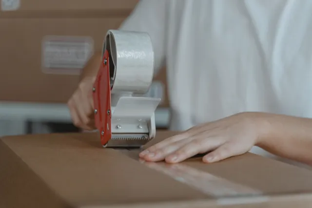Sealing a shipping carton to Amazon packaging requirements with a tape gun